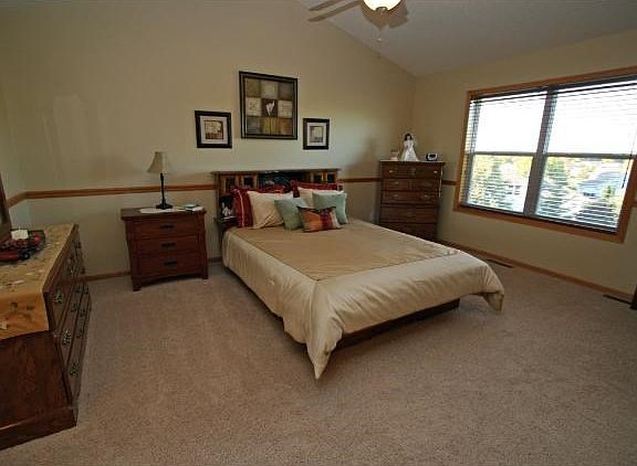 Luxury Master Bedroom w/ high vaulted ceilings, French doors and walk-in closet.