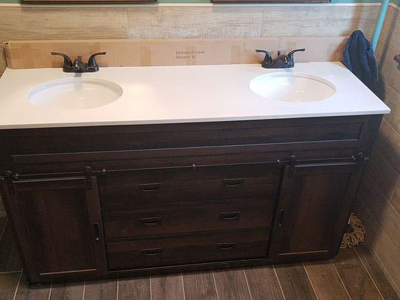 Double sink sitting on a beautiful brand new vanity!