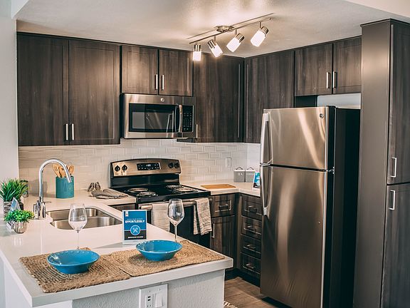 Upgraded kitchen with espresso cabinets and tile backsplash