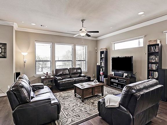 Spacious living has crown molding, hardwoods, and abundant natural light.