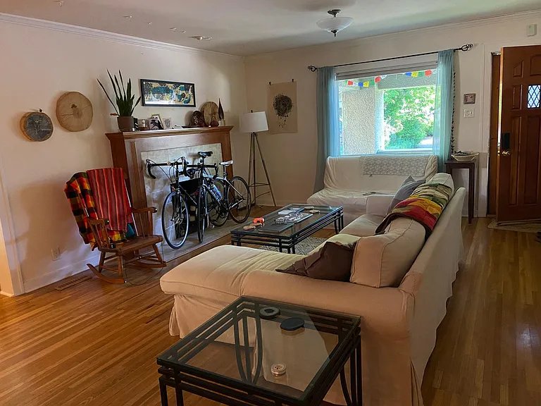 April 2025-Looking backward toward front door and large window looking north to porch and narrow, quiet road.