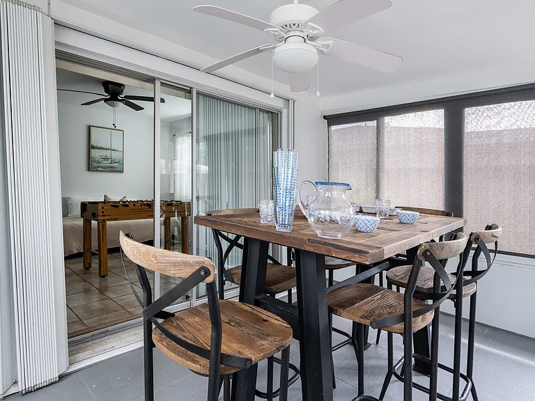 Off of the bonus area is the glassed-in sunroom with an outdoor dining table.