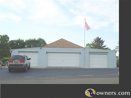 Separate 4-car garage with workbench, extra room, power doors