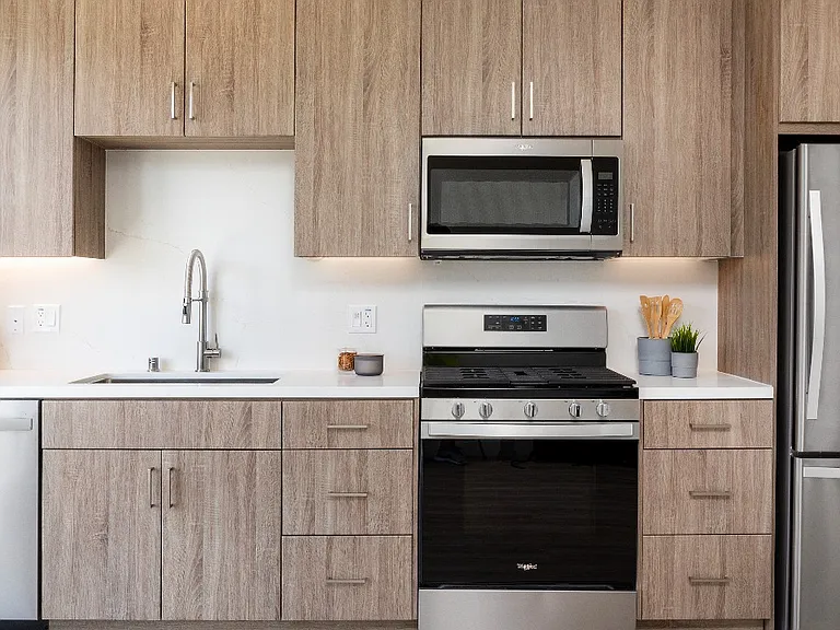 Ash Brown Kitchen Option with large moveable island, Modern Cabinets, Stainless Steel Appliances, quartz countertops and backsplash