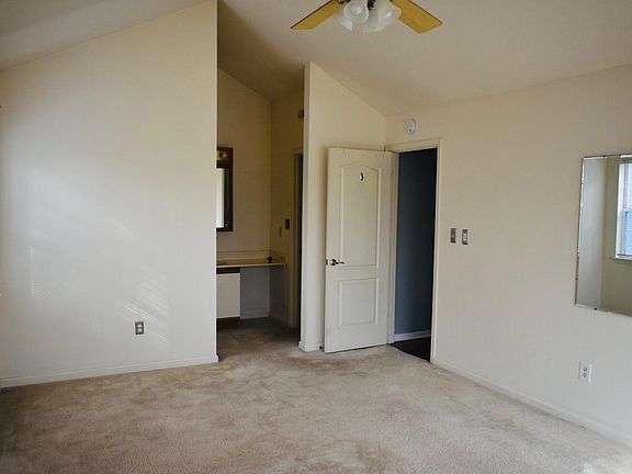 Full bathroom in master bedroom with walk-in closet and vaulted ceiling