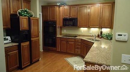 Kitchen
						:
						Granite counters, under counter lighting, wood panels on refrigerator