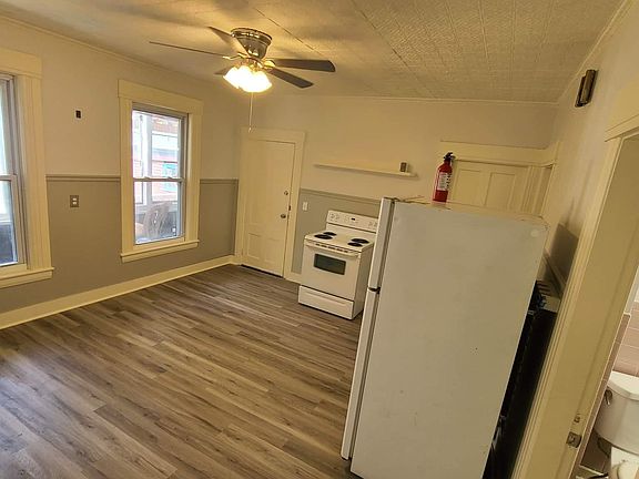 Eat in kitchen with Stove, refrigerator, and washer machine.