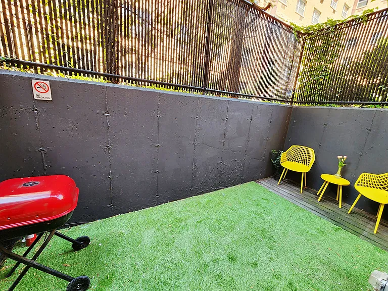 Backyard large enough for BBQ and small gatherings.