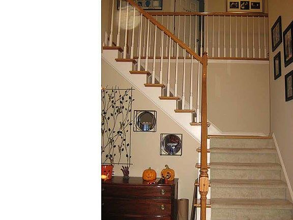 Two story entry with unique center staircare
