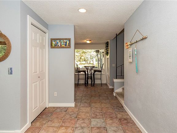 Entry, to your left, leads you to the living room. Straight ahead and to your right, leads you to Primary bedroom, 2nd bedroom, main bath, laundry rm and family room with wet bar!