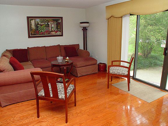 Living room with hardwood floors and sliding doors to the patio.