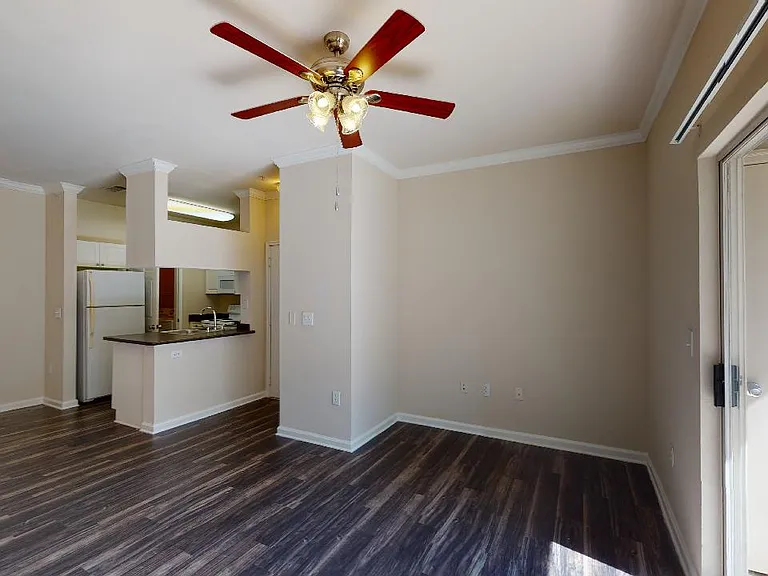 Gourmet kitchen, dining and living room with plush carpet or wood-style flooring.