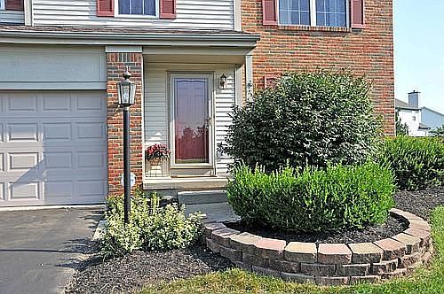 Hang a Seasonal Wreath on this Cheerful Brick Red Front Door!