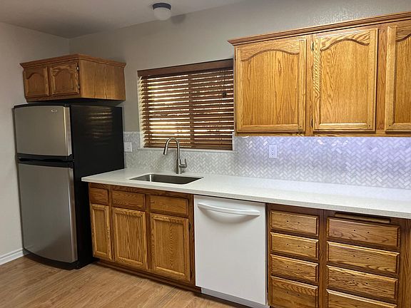 Kitchen with dishwasher and newer fridge included.