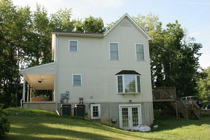 Back of house facing North/garden plot in back yard. Walk-out basement shown.