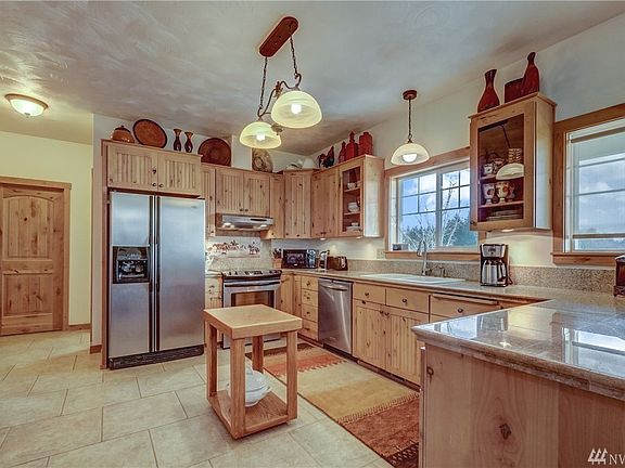 The huge kitchen has stainless steel appliances, granite countertops and a walk-in pantry. 