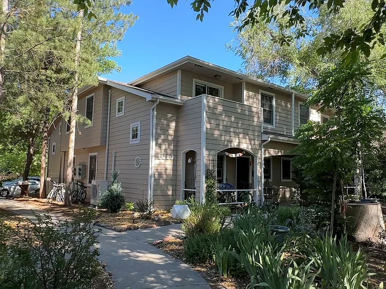 Beautiful common walkways surrounded by mature trees create a welcoming community feel.