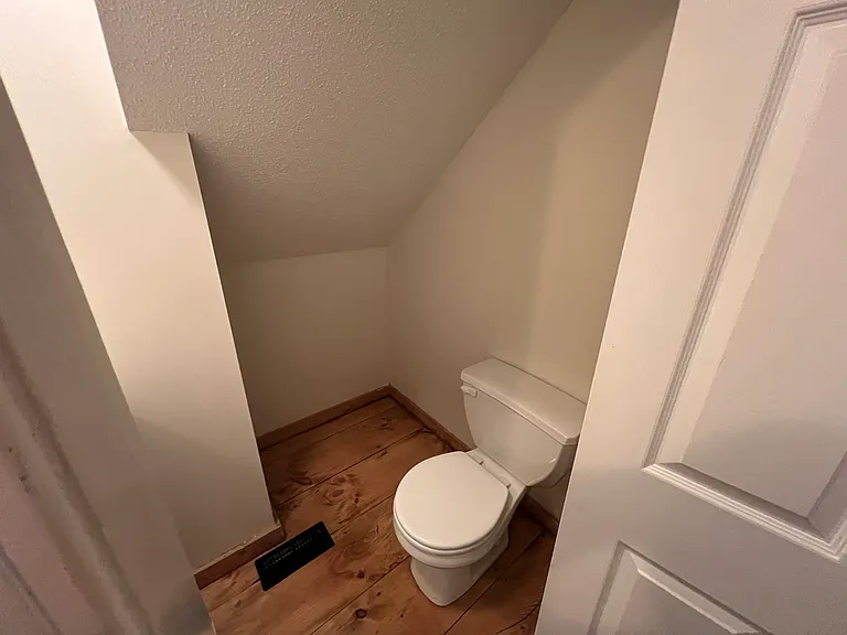 Hall bath toilet. Located in hallway.