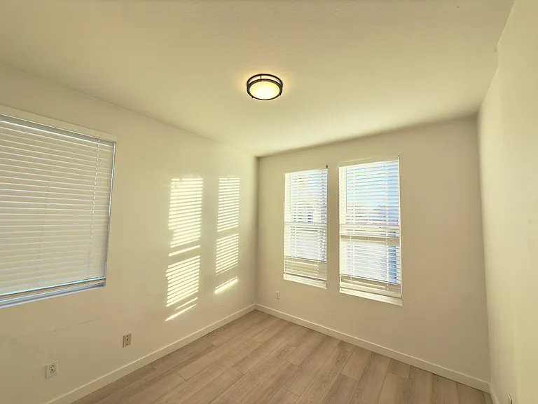 Room 1: Bright and airy, this room enjoys natural sunlight streaming in through windows on two sides. Perfect as a cozy bedroom or a versatile home office, offering flexibility to suit your needs.