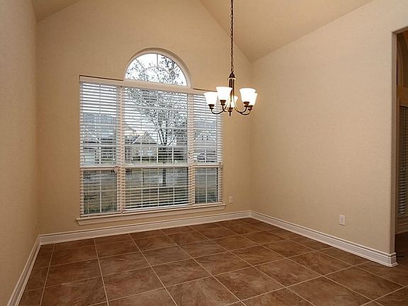 View of Formal Dining Room with arch window above wall of windows
