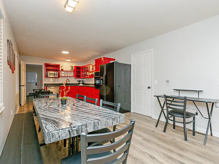 Dining area and kitchen leading into the gameroom at the far end.