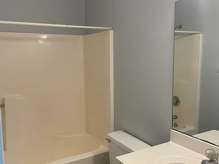 The front bath has a large vanity and a large mirror with great lighting.