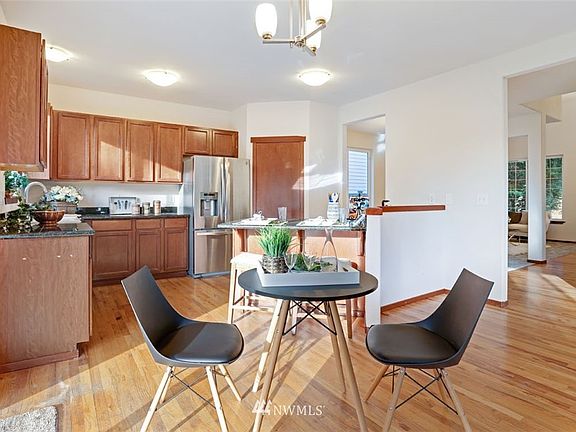 Generous kitchen includes walk-in pantry and room for both bar and table eating area