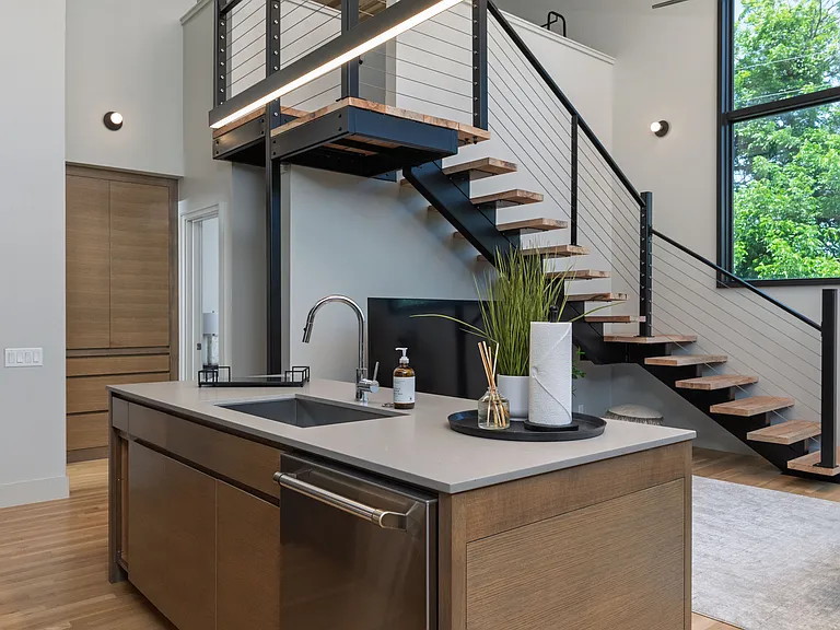 Open concept kitchen with seating for 4 at the kitchen island. The kitchen is fully stocked and ready to use.