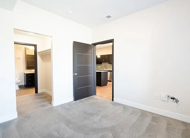 Bedroom with Lush Carpet and Modern Lighting Bedroom with Lush Carpet and Modern Lighting