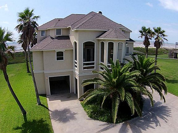 Street side of this unique home showcases the arched turret with a glass chandelier. The arches are 
