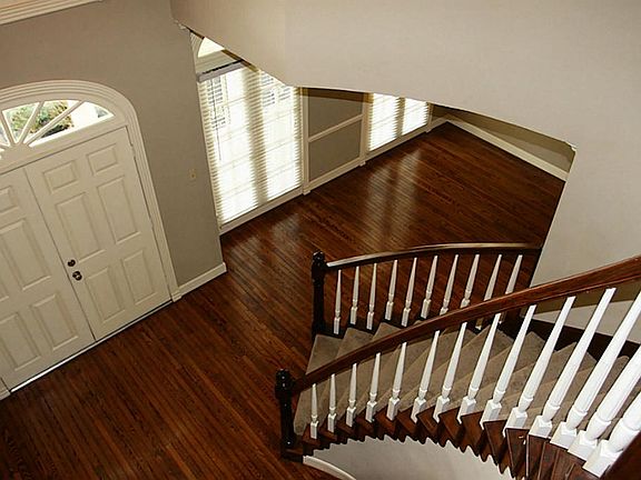 The Elegant Entry Has a Gorgeous Sweeping Stairway, Custom Woodwork and Beautifully Refinished Original Hardwoods.