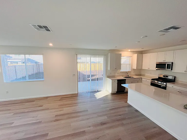 Kitchen view and backyard sliding door... w/ blinds installed