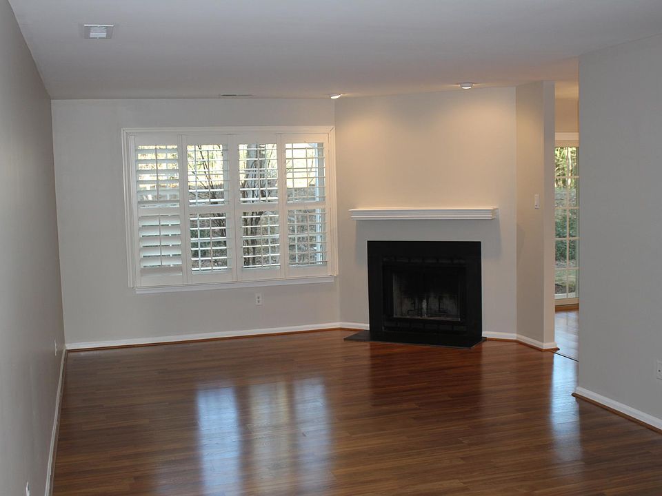 Welcoming entry way with coat closet and wood burning fireplace in the living room.