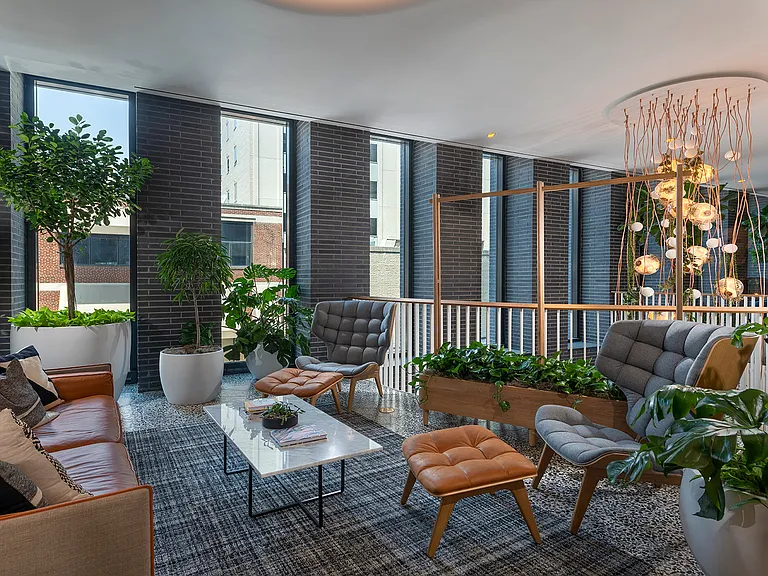Your vibrant entry to your community is designed with elements of wood, stone, and water