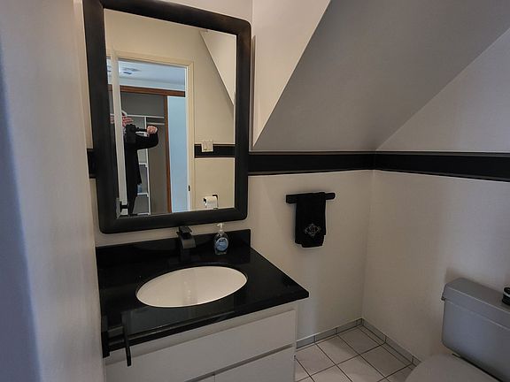 Convenient half bathroom on the main level, ideal for guests.