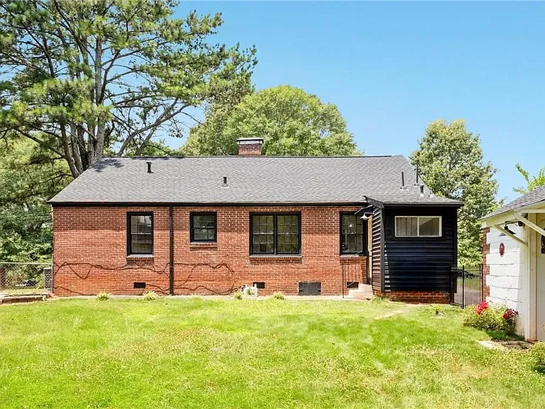 Back of house with fenced in yard and enclosed garage(storage only)
