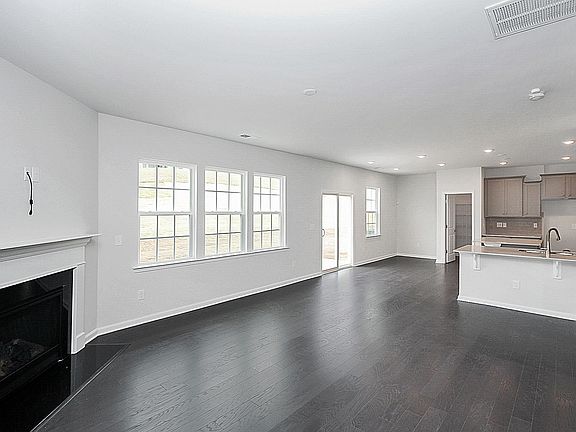 View from Gathering Place toward Breakfast Area and Kitchen. Gas Log fireplace.