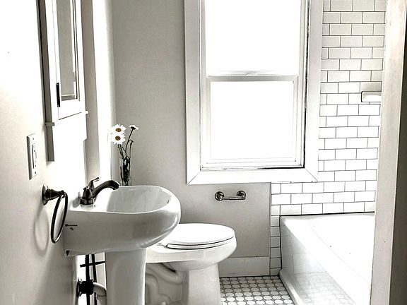 New main floor bath with time-period hardware and tile. Spacious built in linen/towel closet w/ a sweet and handy laundry shoot.