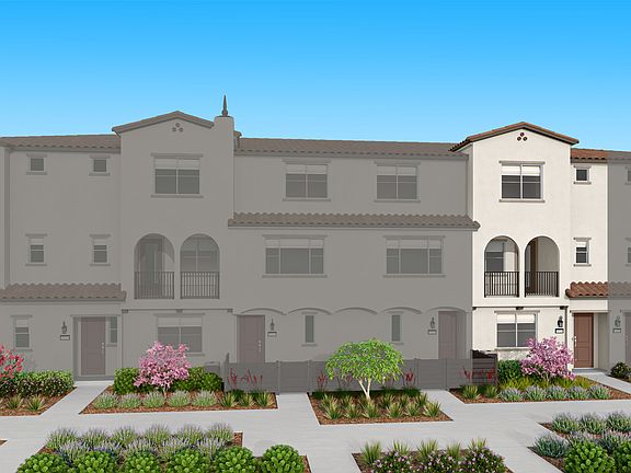 A multi-story residential building with a Mediterranean-style architecture, surrounded by a well-man