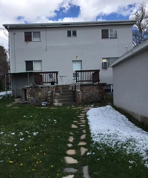 view of back deck, garage and back of building.