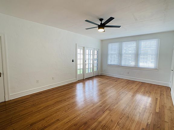 Large living room, viewed towards the 15 panel front door with dual 8 panel sidelight windows