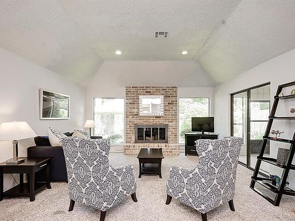 The living room has high ceilings, crown molding and carpet floors (3 yrs old).