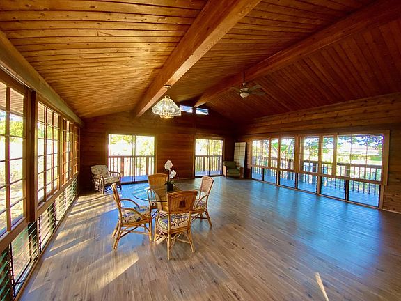Open floor plan for living and dining. Wooden Shoji sliders on both sides of the great room. They are purposely left clear to maximize the view.