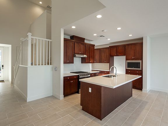 This modern kitchen is a sleek and functional culinary space that combines cutting-edge design with