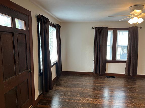 Living space near front door with large windows for natural light.