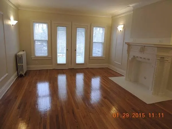 Living rooms, 9' tall ceilings, crown moldings, beautiful Oak floors, French doors and Fireplace.
