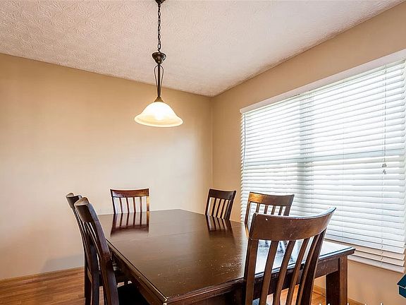 Bright dining space with large windows, ample natural light, and an open layout ideal for daily meals or entertaining.