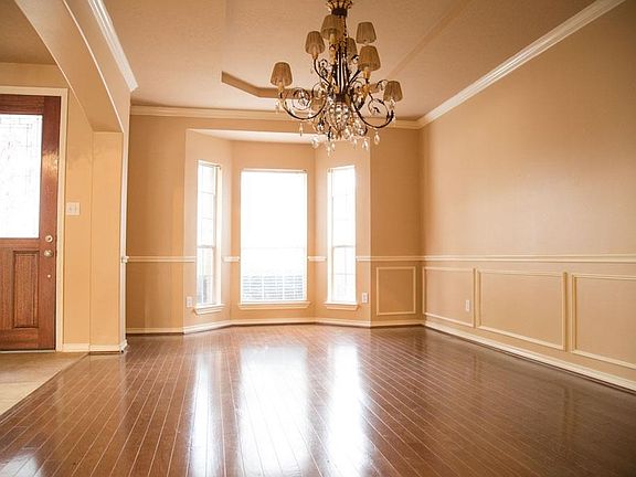 Large formal dining room with beautiful chandelier.