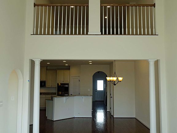 Living room view of kitchen, dining area, front entrance, an
