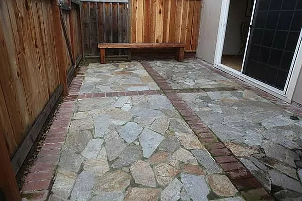 Artfully done Flagstone Patio with Built-in Bench, sliders to Diningroom